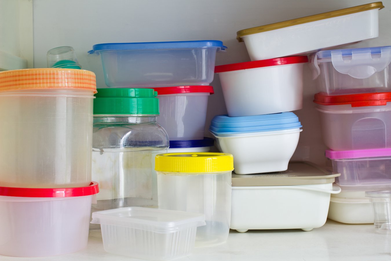 picture of plastic kitchen containers with multicolored lids