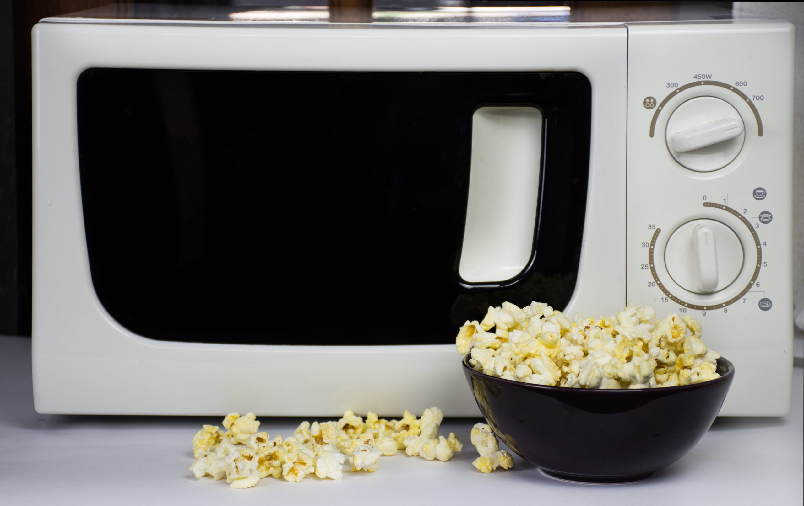 microwave with microwave popcorn sitting in front of it