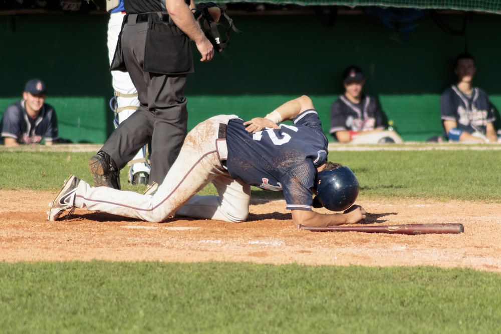 baseball player falling down after being hit